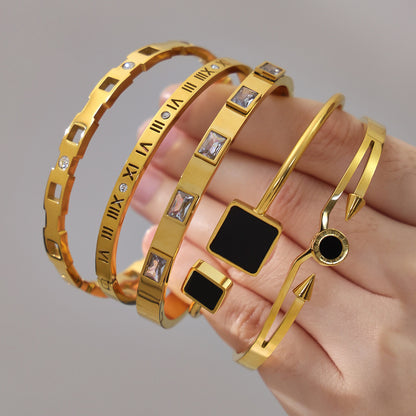 18k gold zircon stainless steel bangle set, held in hand