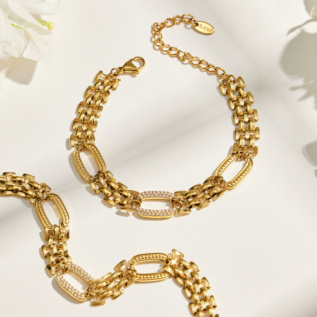 Gold zircon watch link bracelet flat lay showing structured chain design