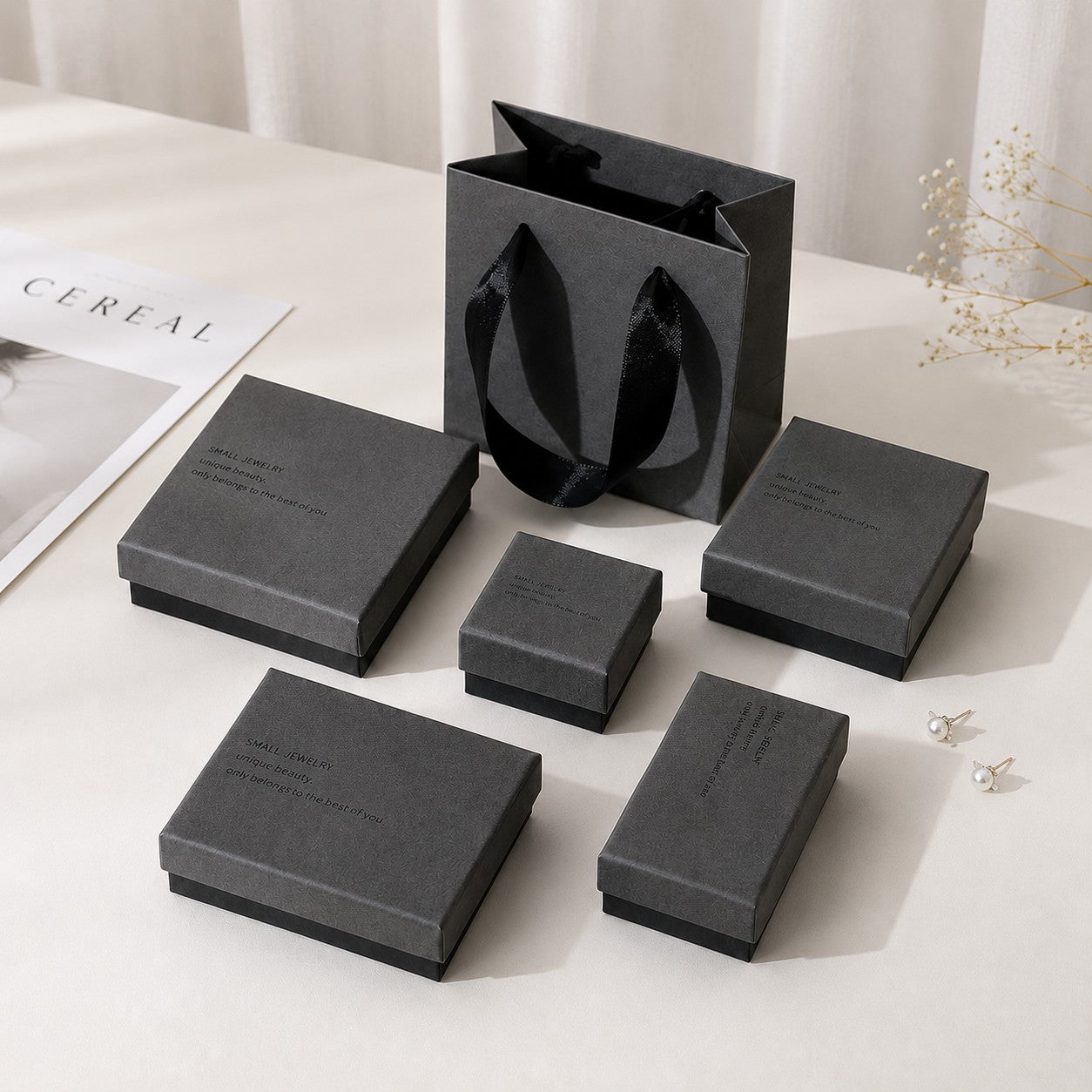 Gray jewelry box packaging set with multiple box sizes and matching gift bag