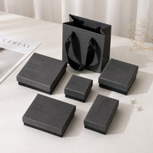 Gray jewelry box packaging set with multiple box sizes and matching gift bag