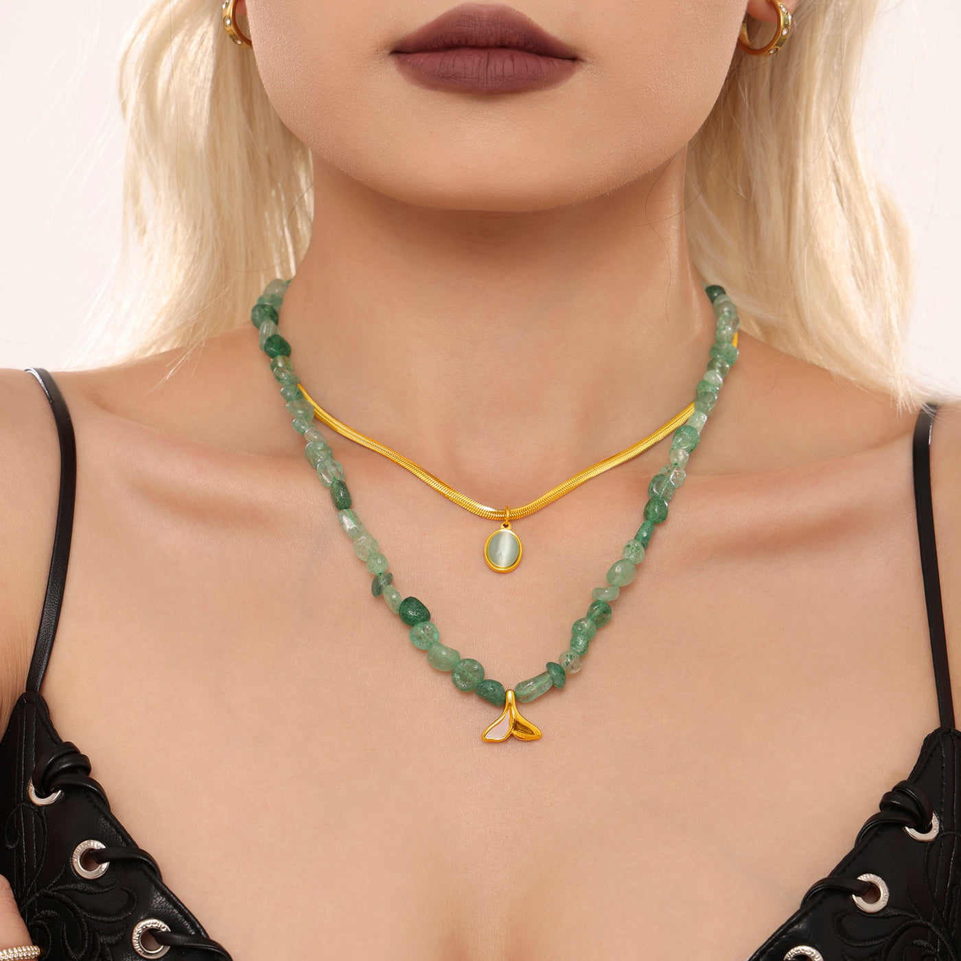 Front model view of a green beaded layered necklace with gold accents