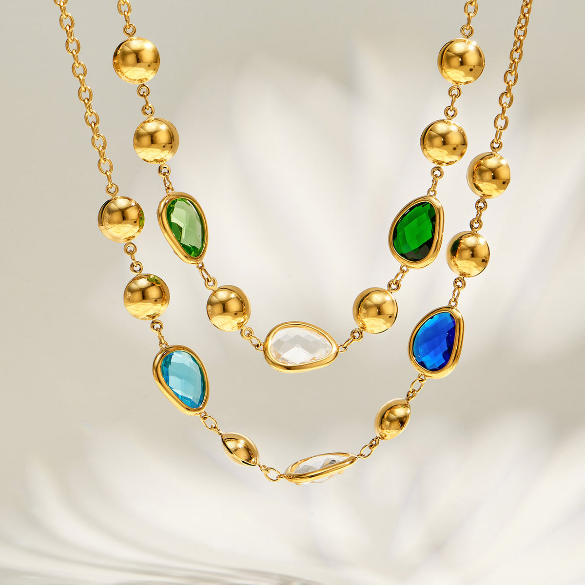 Green and blue glass stone necklaces layered together