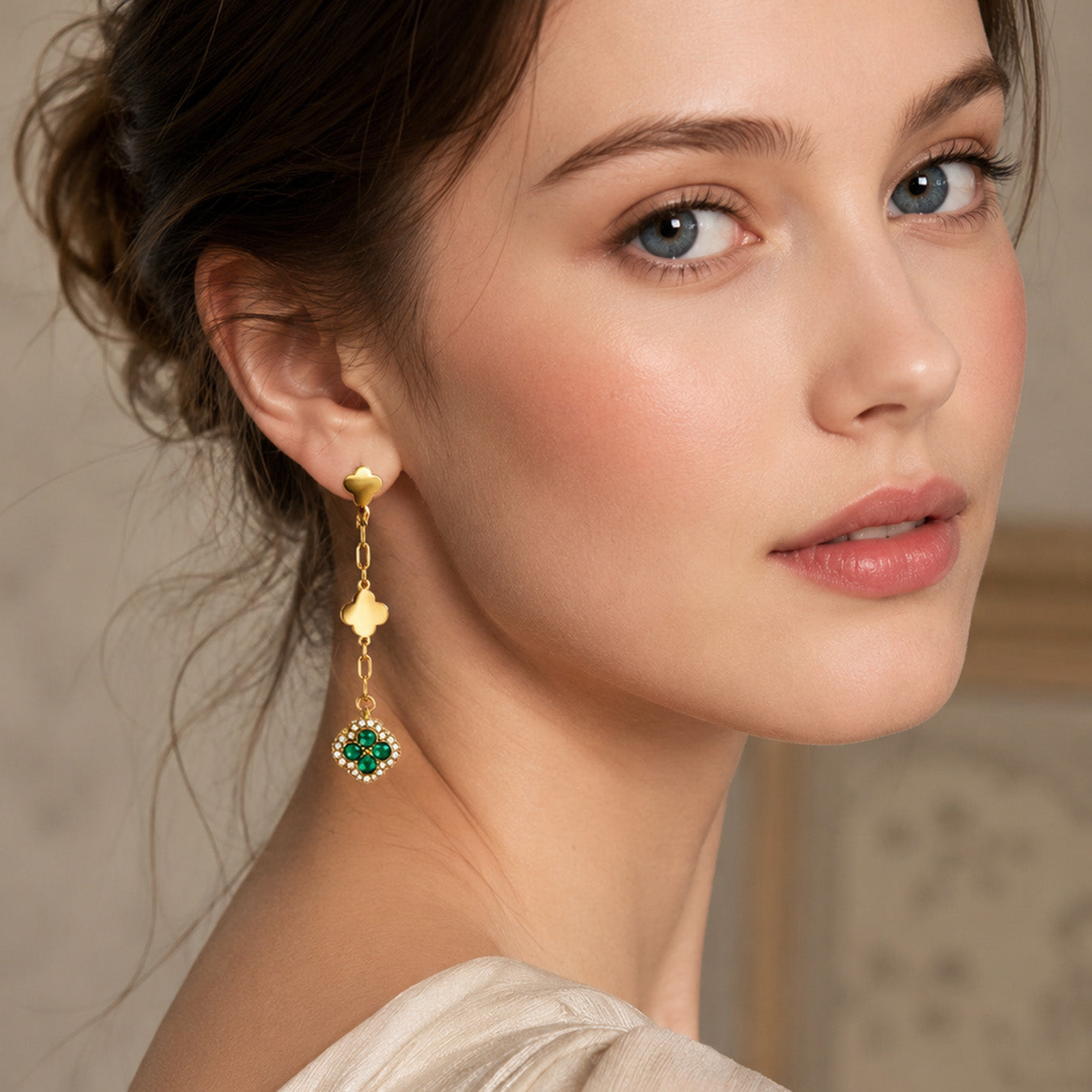 Green crystal gold clover drop earrings styled with an elegant model look
