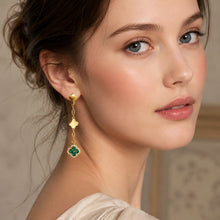 Green crystal gold clover drop earrings styled with an elegant model look