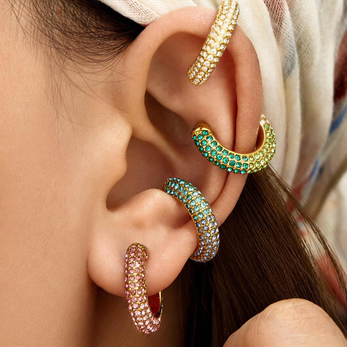 Green cubic zirconia ear cuff styled on the outer ear