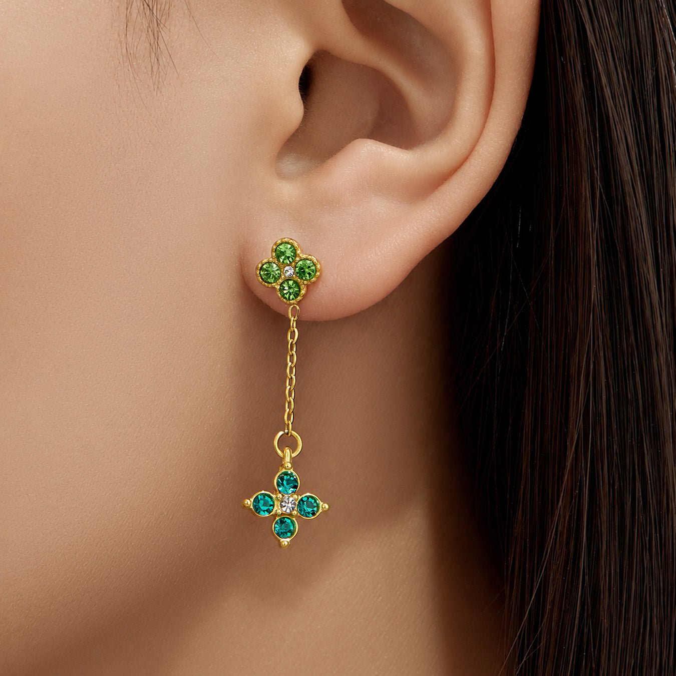 Model wearing green cubic zirconia four-leaf clover drop earrings