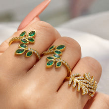 Model wearing green marquise CZ botanical leaf rings with polished 18K PVD gold finish