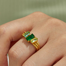 Green emerald-cut cubic zirconia multi-band ring in 18K PVD gold worn on a model finger