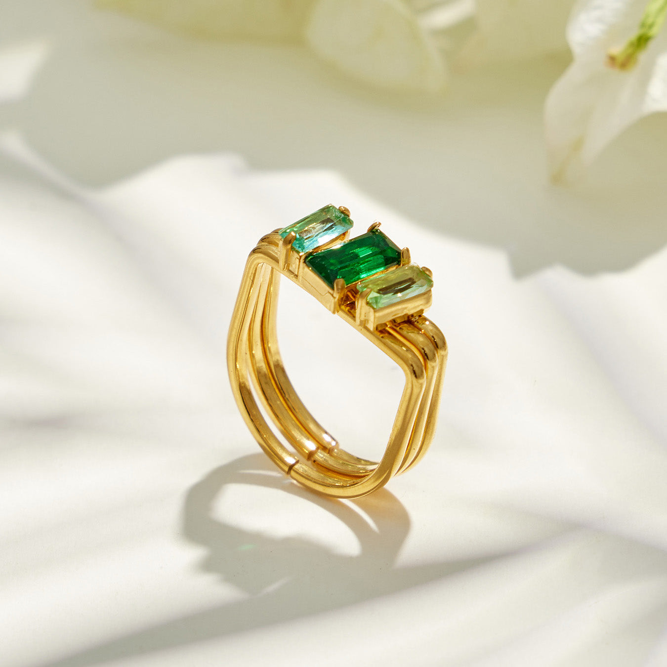 Green emerald-cut CZ 316L stainless steel multi-band ring shown in a clean product display