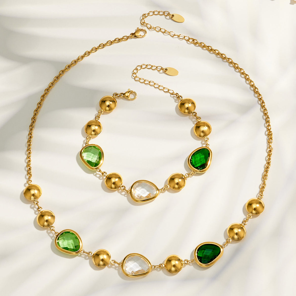 Green glass stone necklace and bracelet flat lay