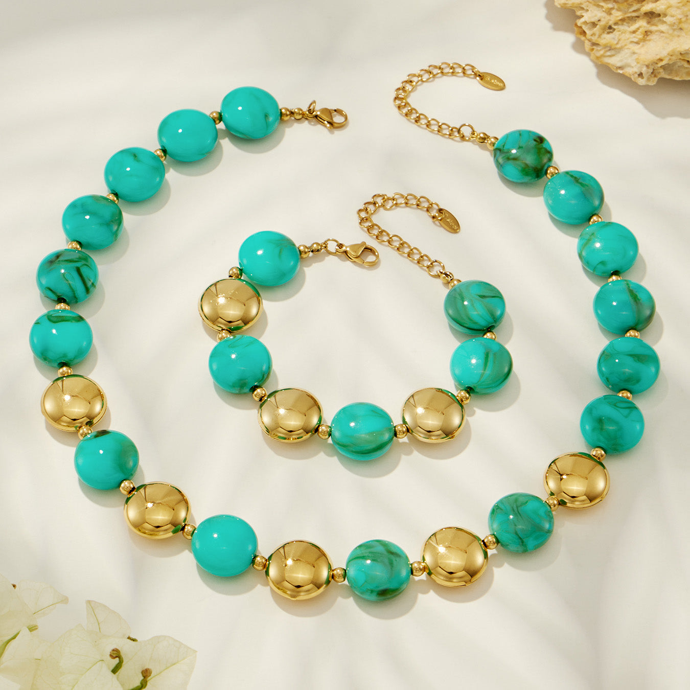 Green resin bead necklace and matching bracelet with gold-tone accents in a clean product display.