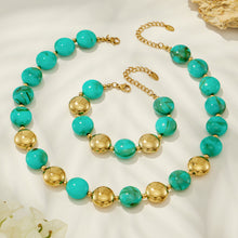 Green resin bead necklace and matching bracelet with gold-tone accents in a clean product display.