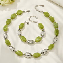 Green organic resin necklace and matching bracelet set with gold metal accents displayed together