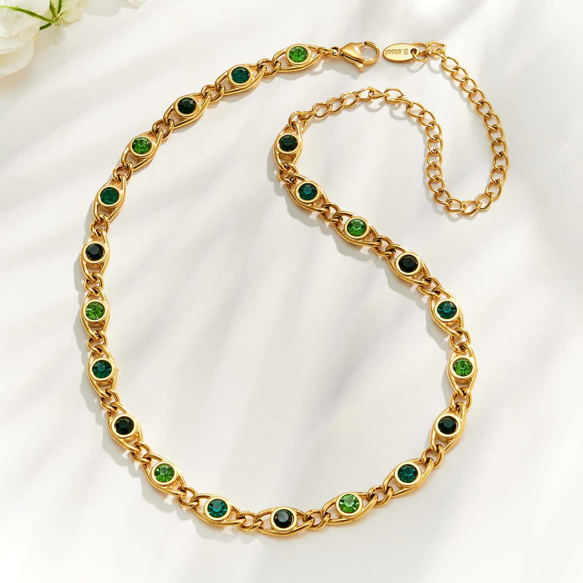Green zircon chain necklace flat lay