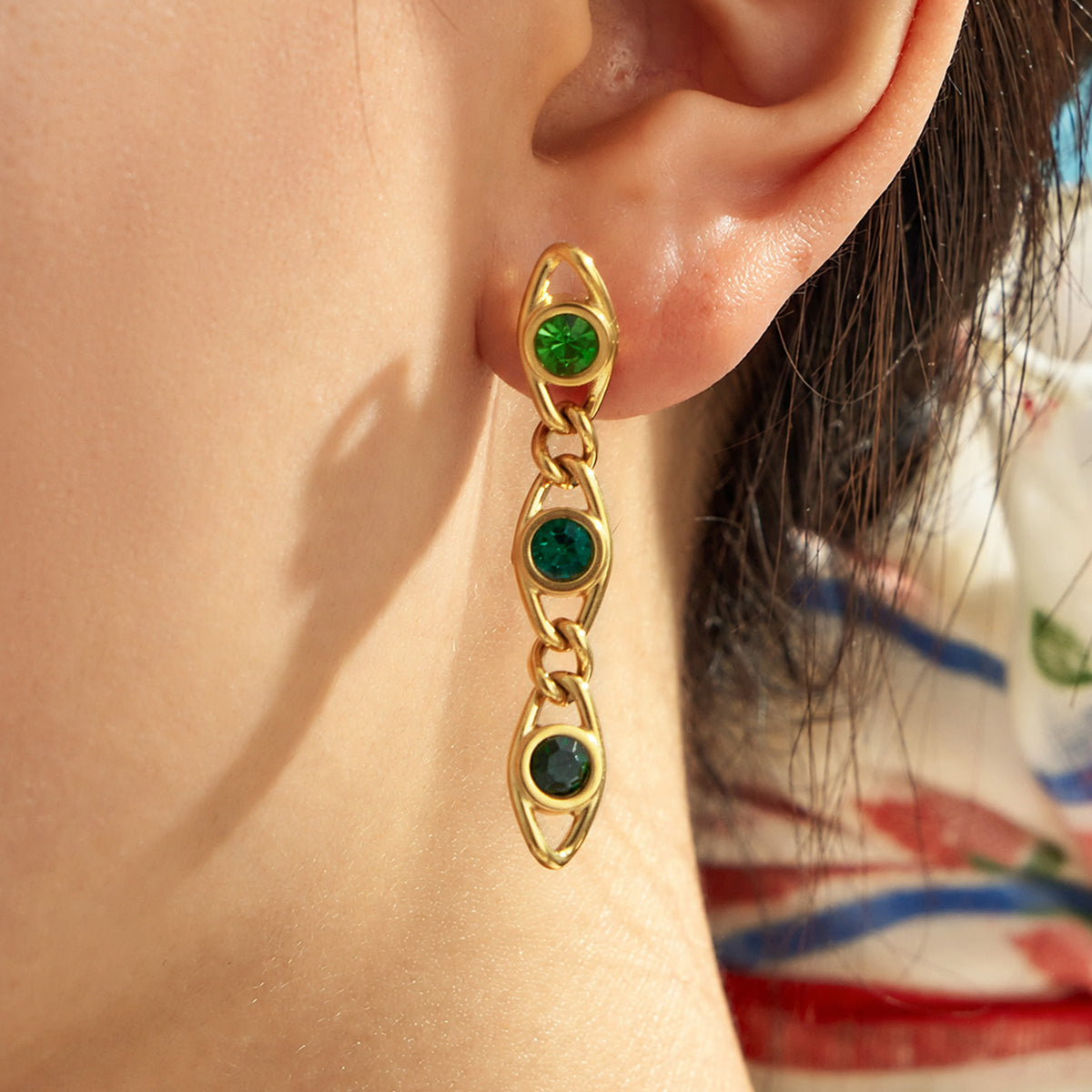 Green zircon drop earrings worn on model