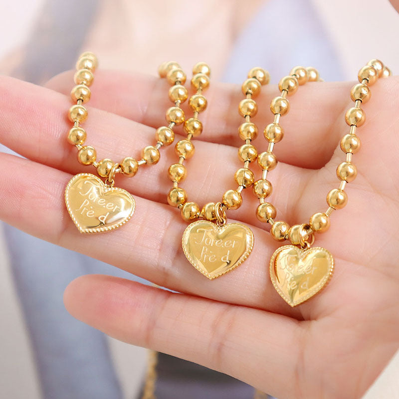 Gold heart charm beaded bracelets displayed in multiple pieces
