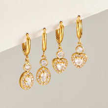 Gold heart and oval zircon hoop earrings displayed in matching charm styles