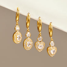 Gold heart and oval zircon hoop earrings shown together as matching jewelry styles