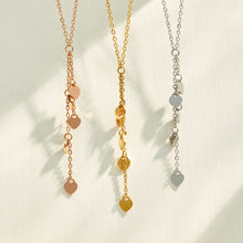 Heart tassel Y necklaces displayed in gold, polished steel and rose gold finishes