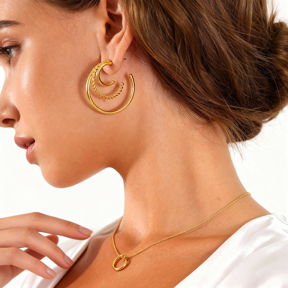 Woman wearing triple layer gold hoop earrings side profile showing 30mm size fit.