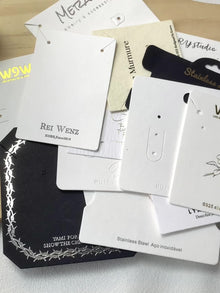 Assortment of black and white jewelry display cards for retail packaging