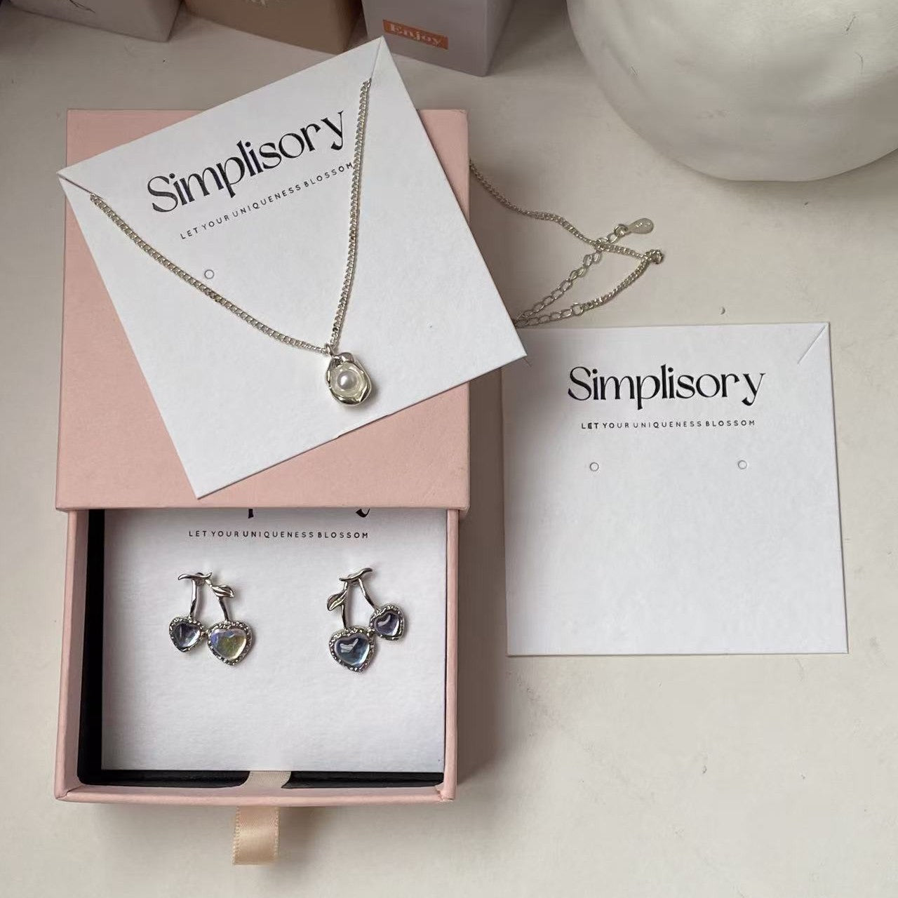 White earring display cards presented inside a jewelry gift box