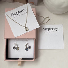 White earring display cards presented inside a jewelry gift box