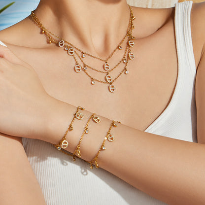 model wearing 18K gold layered coin charm necklace set with waterproof stainless steel jewelry
