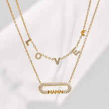 Model wearing a layered gold necklace arrangement with a MAMA zircon bar pendant