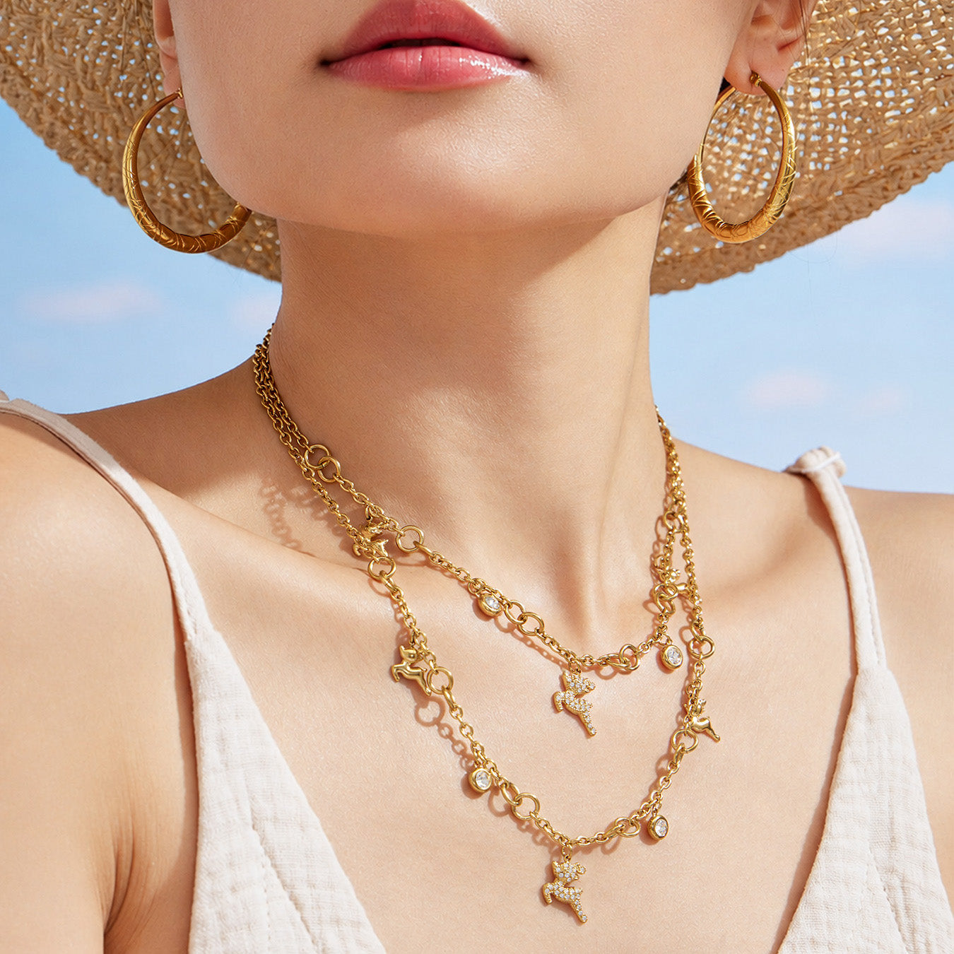 Model wearing a layered gold reindeer zircon necklace with a festive animal motif