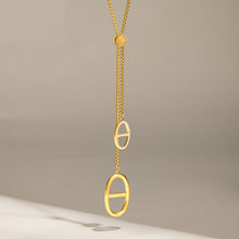 Long geometric zircon lariat necklace with 18K gold PVD finish and vertical drop design