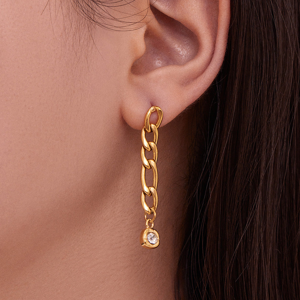 Side view of a model wearing a long gold chain drop earring