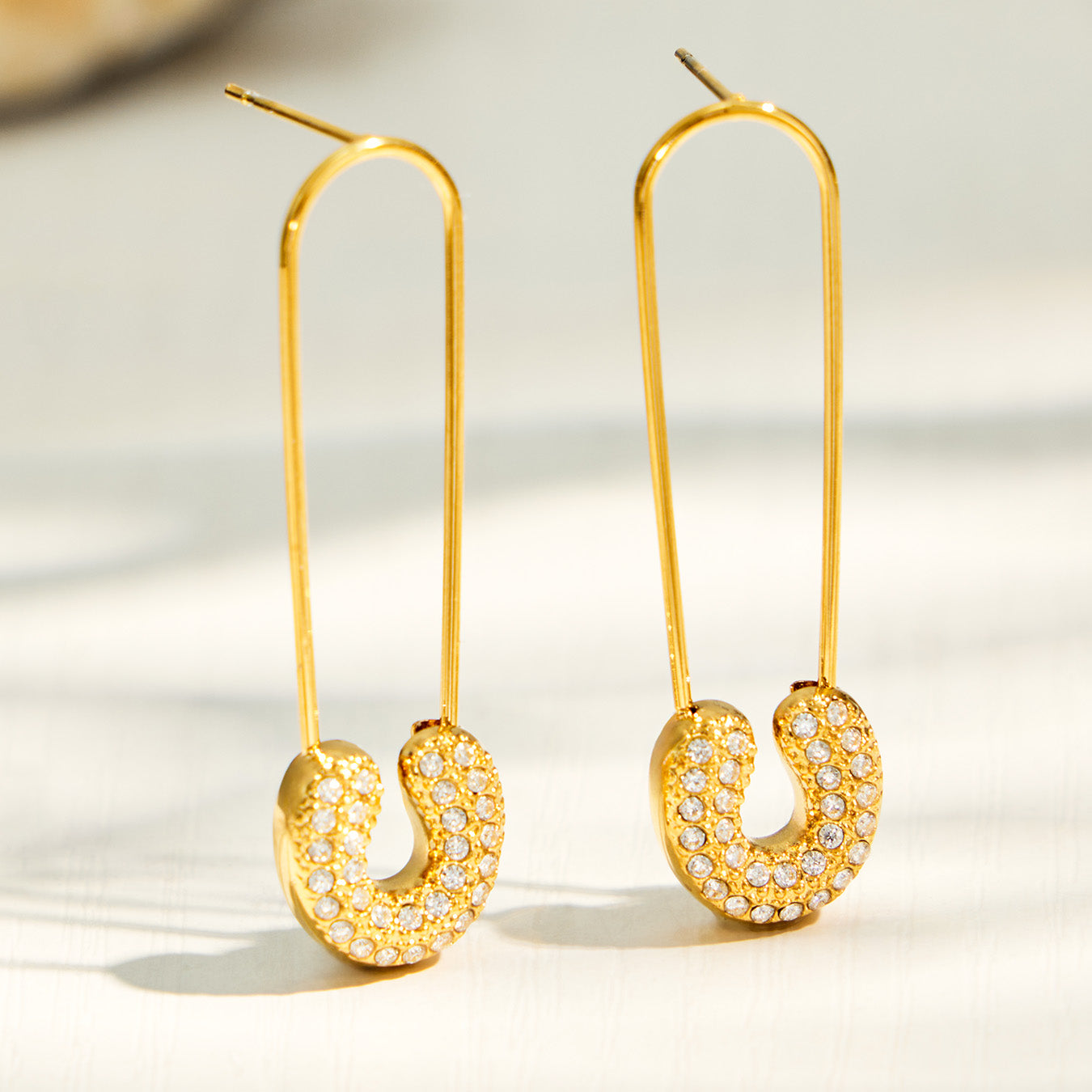 Long paperclip-inspired drop earrings with clear CZ detail