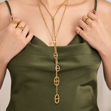 Long gold zircon lariat necklaces with geometric drop links layered on model