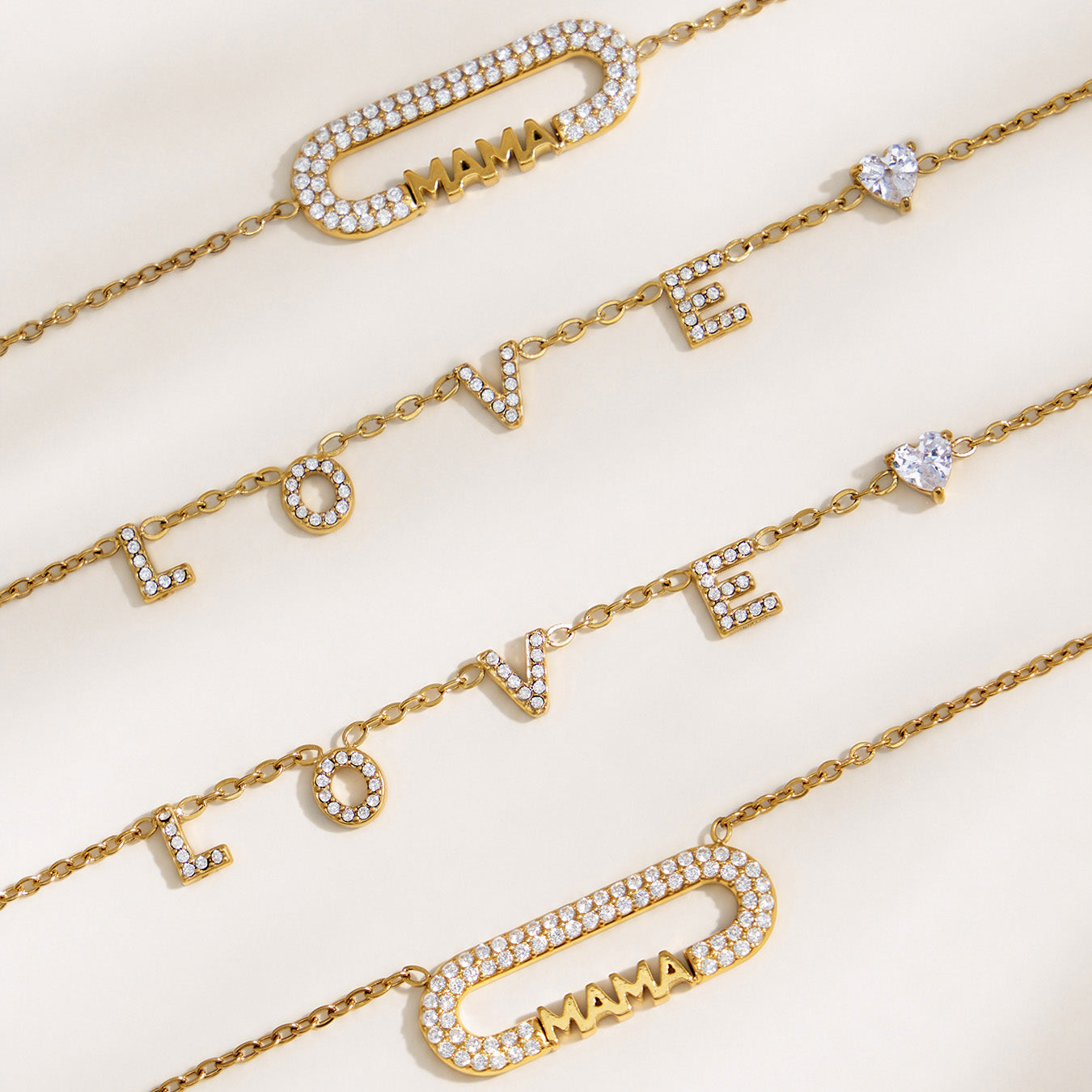 Detailed view of MAMA letter jewelry chains, zircon bar accents and polished gold finish