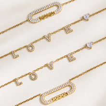 Detailed view of MAMA letter jewelry chains, zircon bar accents and polished gold finish