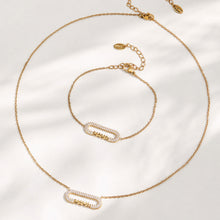 MAMA zircon bar necklace and matching bracelet arranged in a circular flat lay