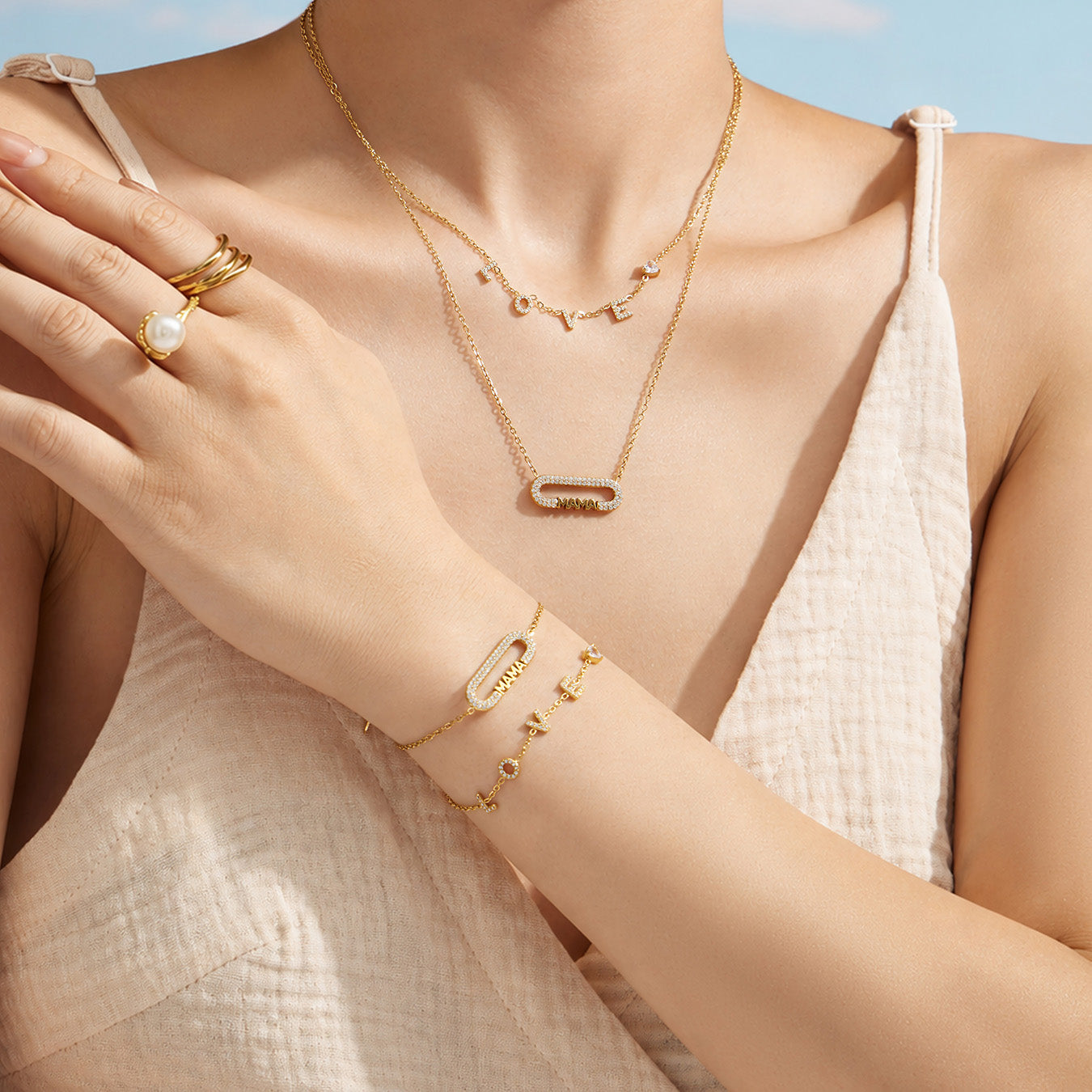 Model wearing a MAMA zircon necklace with a coordinating bracelet and white outfit