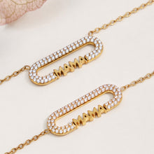 Close-up of the clear zircon frame and MAMA lettering on gold-tone jewelry