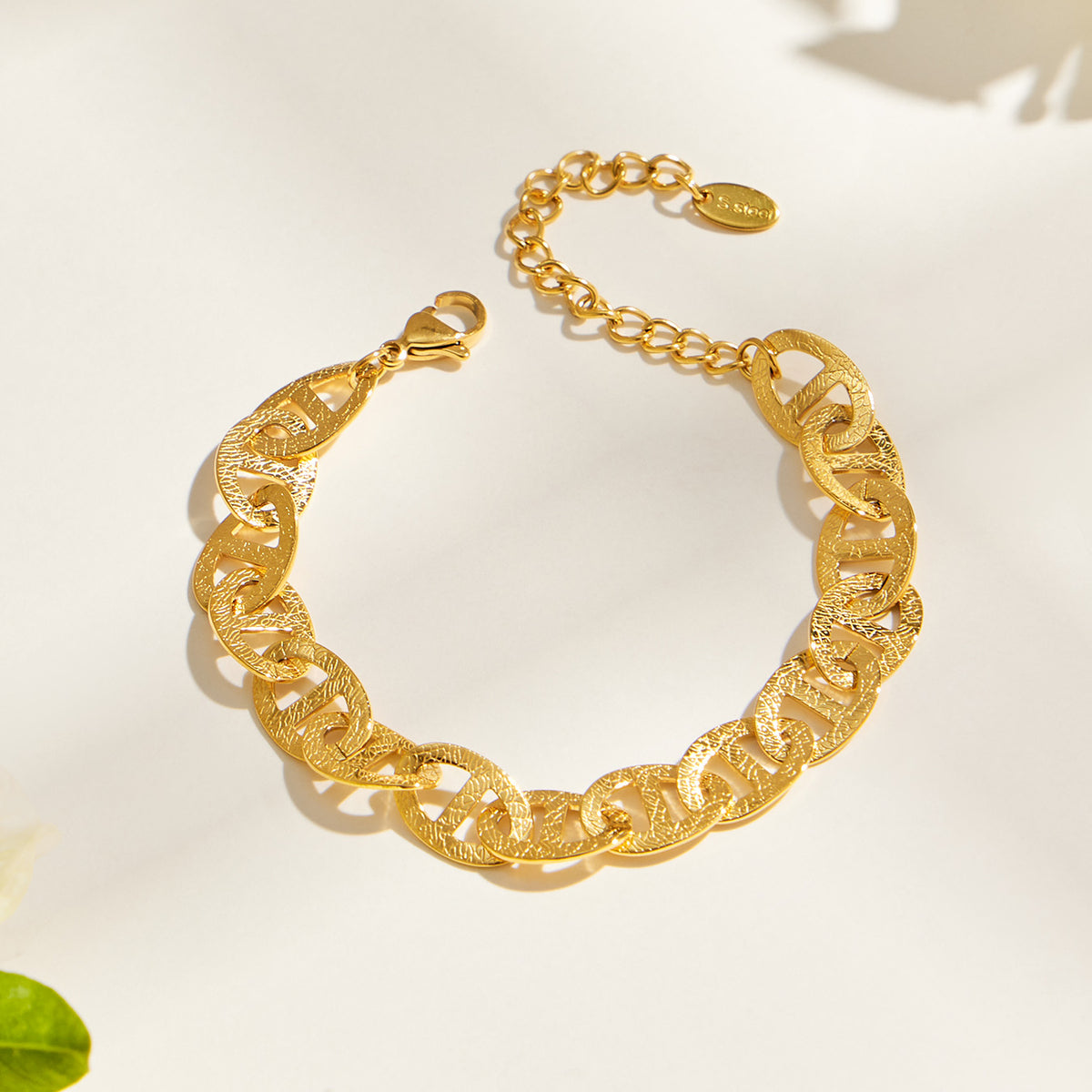 Gold mariner chain bracelet flat lay showing center-bar links