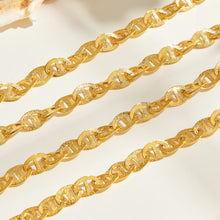 Close-up of gold mariner chain links with center-bar design
