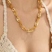 Gold-tone mariner link necklace worn at the neckline