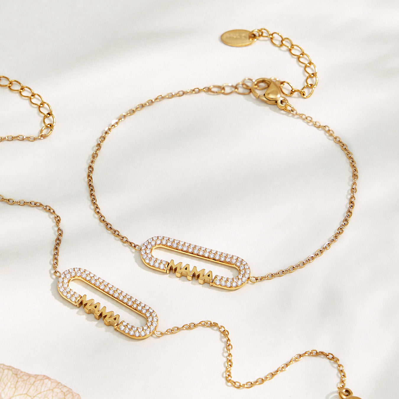Matching MAMA letter necklace and bracelet displayed together on a neutral background