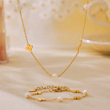 Matching freshwater pearl clover necklace and bracelet displayed with delicate gold chains