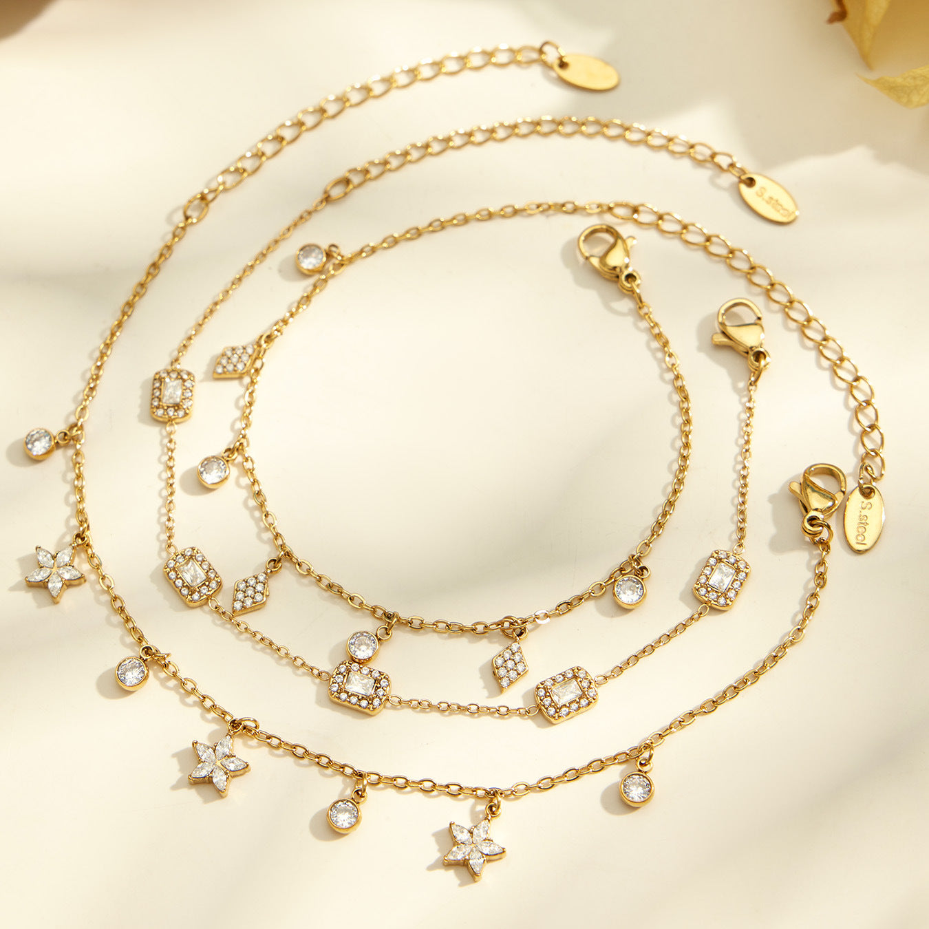 Flatlay of matching zircon charm necklace and bracelet styles for wholesale jewelry assortments