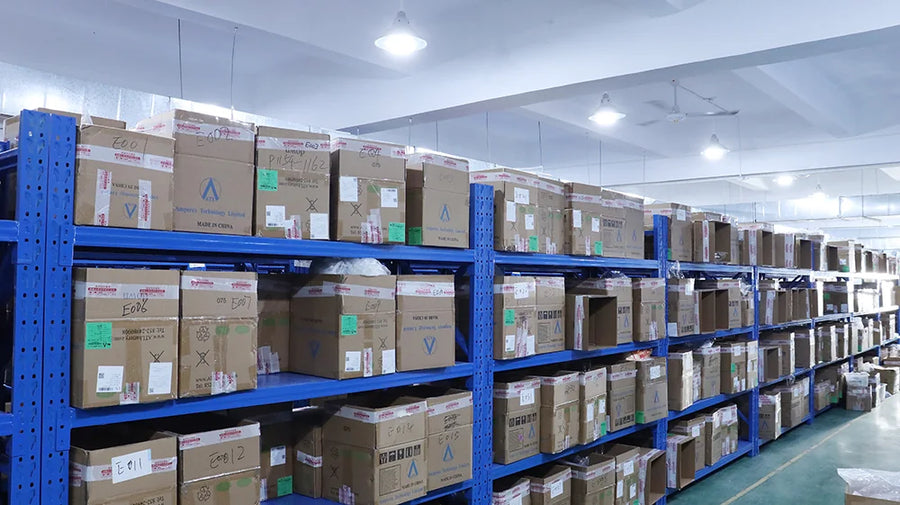 Stock storage shelves with labeled cartons and blue inventory bins