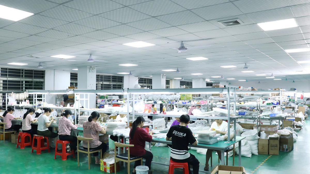 Jewelry workshop with staff working at long production benches