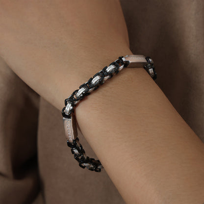 Side wrist view of men’s black steel link bracelet showing heavy chain structure and stainless steel finish