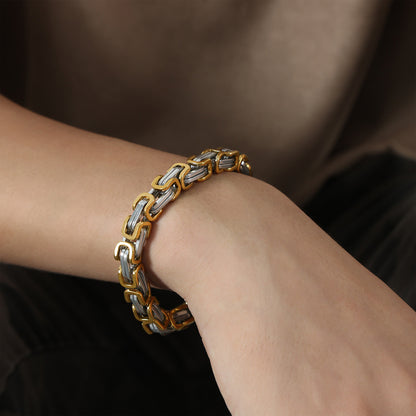 Men’s two-tone gold and steel link chain bracelet worn on wrist, made with stainless steel for boutique wholesale collections