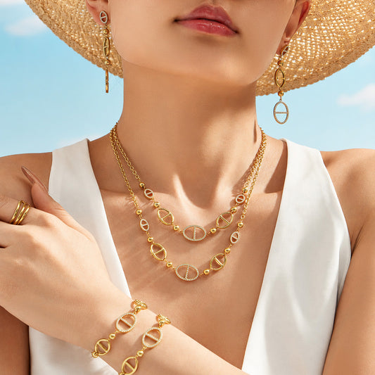 Model wearing gold geometric zircon necklace and drop earrings for resort jewelry styling by Miduoduo Jewelry